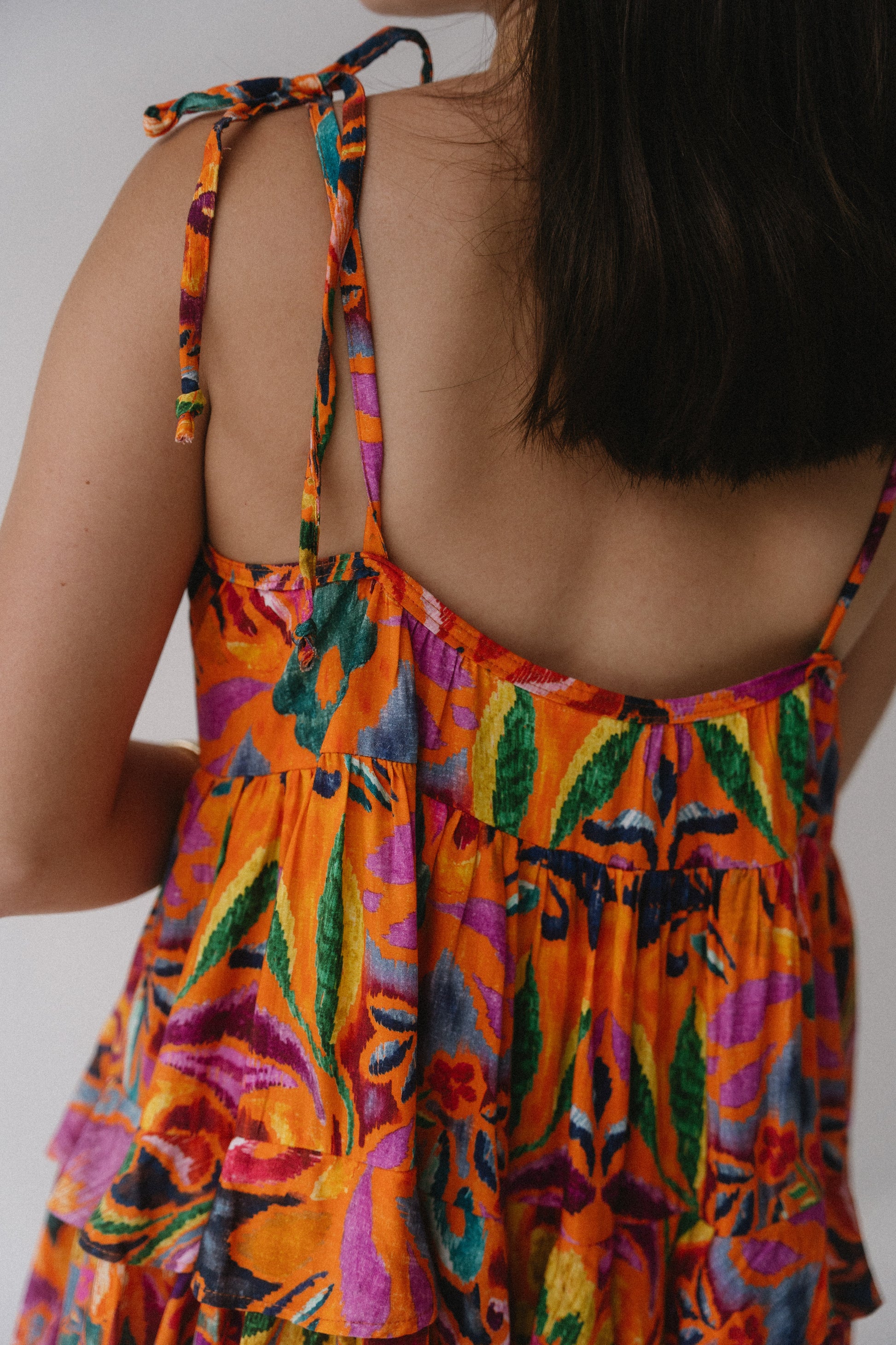 Colorful dress with floral pattern on a plain background