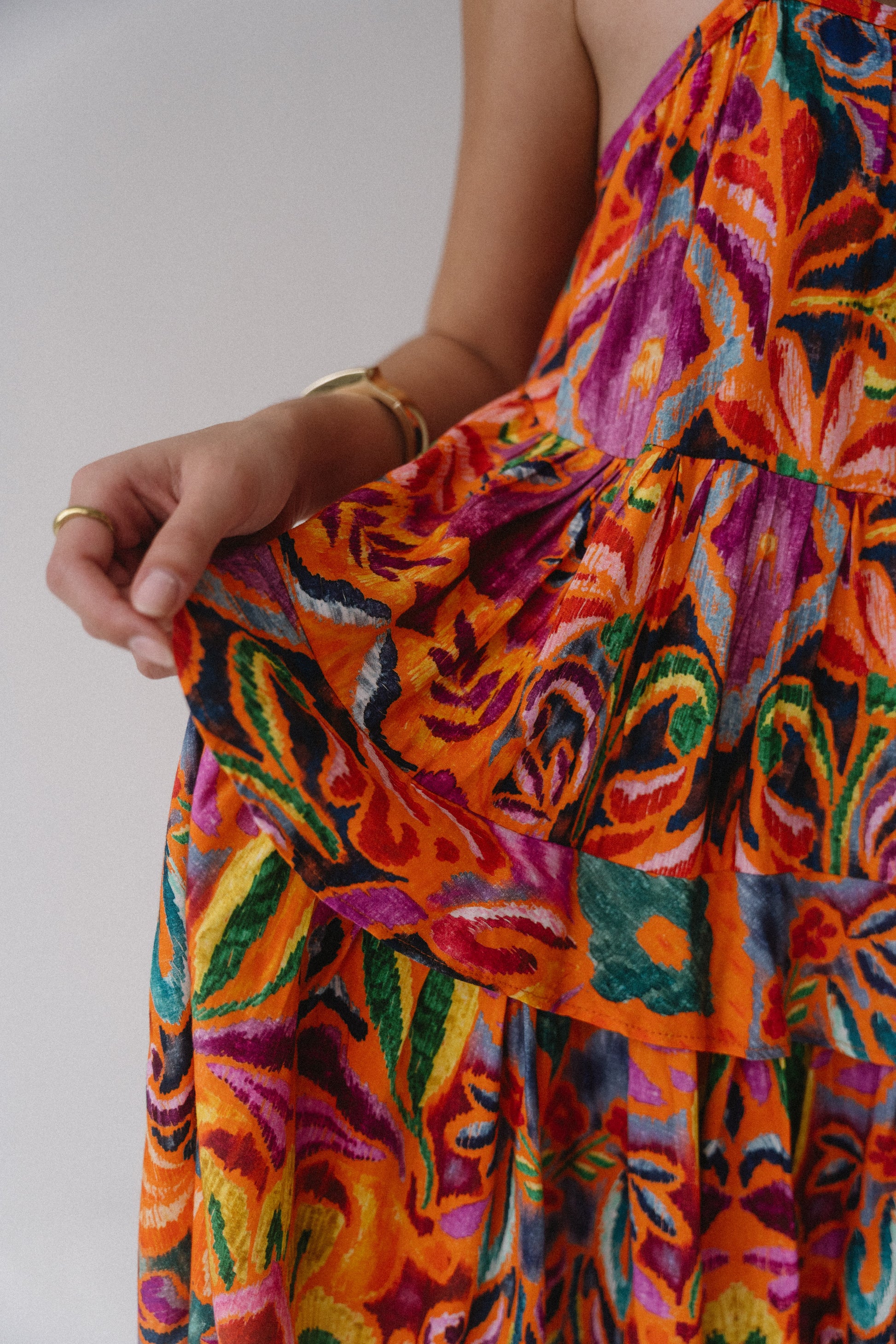 Colorful floral dress with vibrant patterns on a plain background